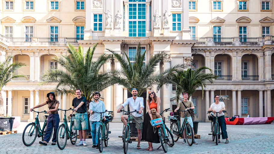 Group with bikes in front of a building.