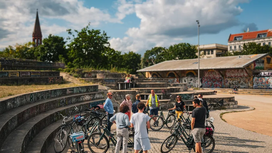 People with bikes gather in a park.