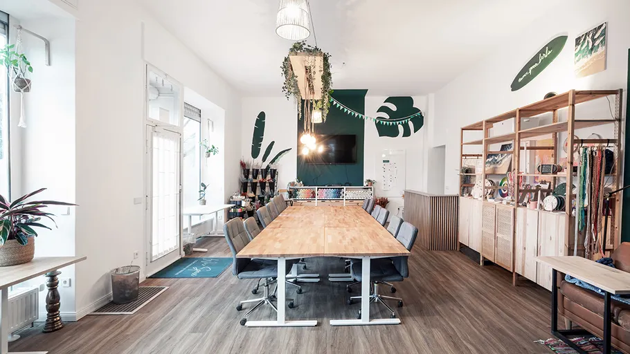 Conference room with long table, chairs, and decor.