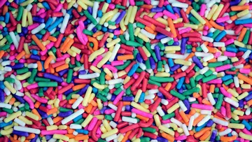 Colorful sprinkles scattered on a surface.