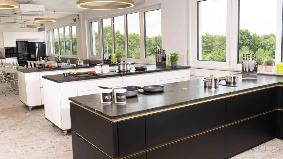 Modern kitchen with islands and large windows.