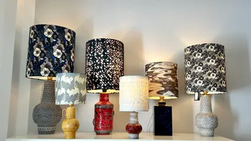 Various decorative table lamps displayed on a shelf.