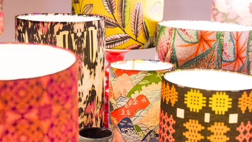 Colorful patterned lampshades in a display setting.