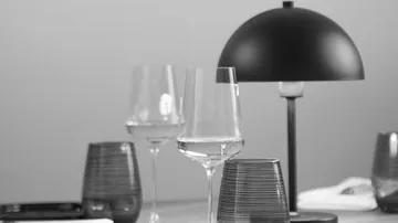 Wine glasses and lamp on table.