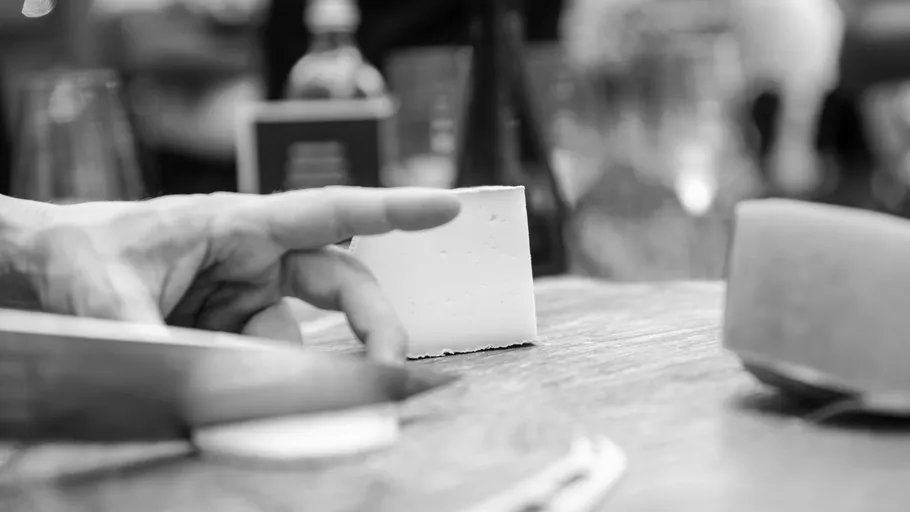 Cheese cutting on a wooden board.