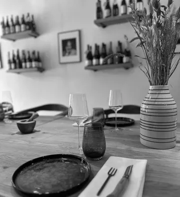 Table set with plates and wine glasses.