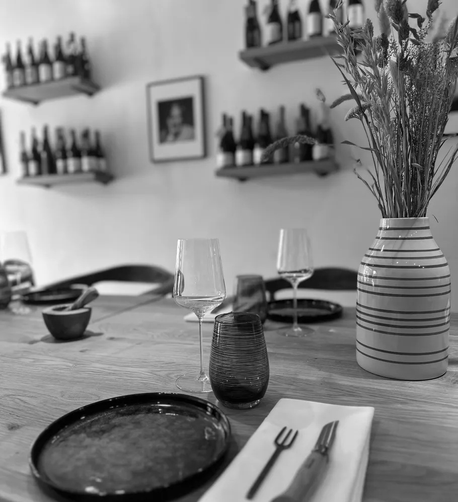 Table set with plates and wine glasses.