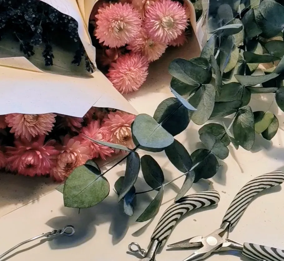 Flowers and tools on a crafting table.
