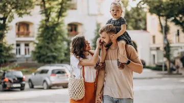 Family walking in a city street environment.