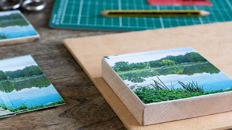 Photo mounted on wooden block, crafting materials nearby.