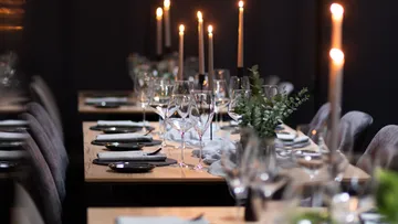 Elegant table setting with candles and glasses.