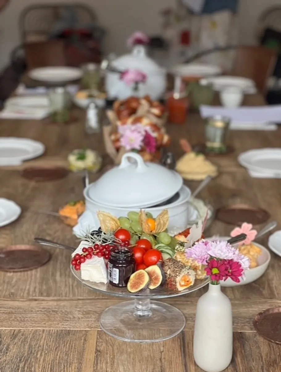 Table set with dishes and decorative flowers.
