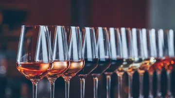 Row of wine glasses with different wines.