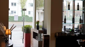 Restaurant interior with glass door and shelves.