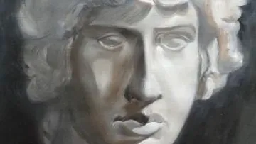 Stone bust with curly hair, shadowed background.