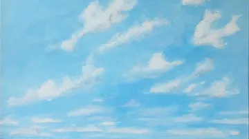 White clouds drifting in blue sky.
