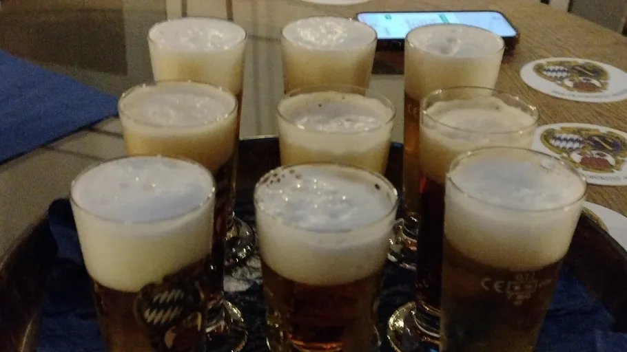 Glasses of beer on a table with coasters.