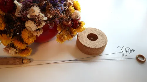 Dried flowers in vase on table.