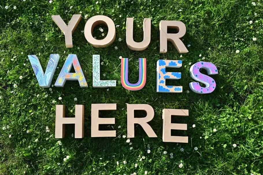 Colorful letters form words on grass.