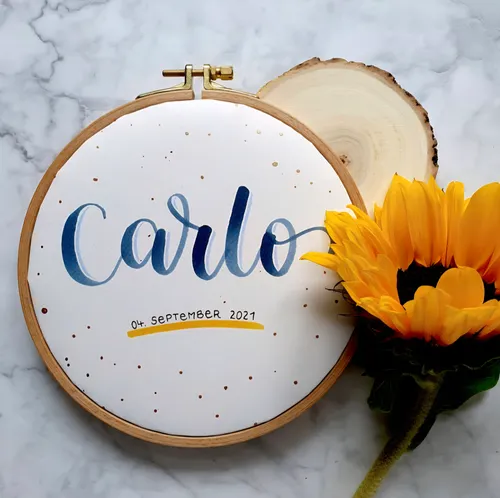 Embroidery hoop with name and sunflower decoration.