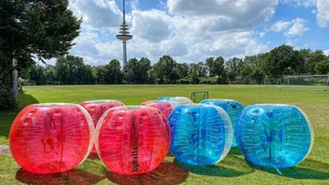 Inflatable bumper balls on a grassy field.