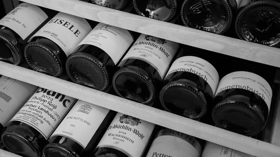 Wine bottles stored in a wooden rack.