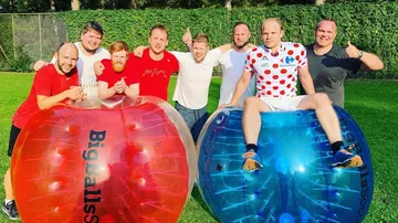 Group of men with inflatable balls outdoors.