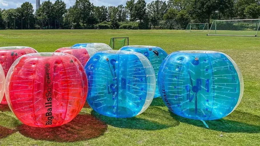 Inflatable balls on a grassy field.