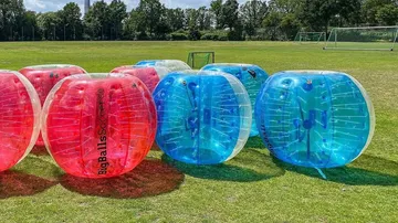 Inflatable bumper balls on soccer field.