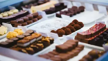 Various chocolates displayed on white trays.
