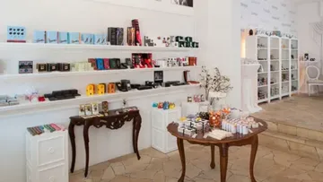 Chocolate shop interior with shelves and tables.