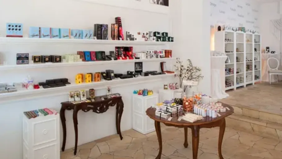 Chocolate shop interior with shelves and tables.