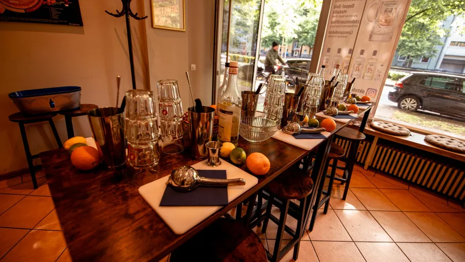 Bar table setup with cocktail equipment indoors.