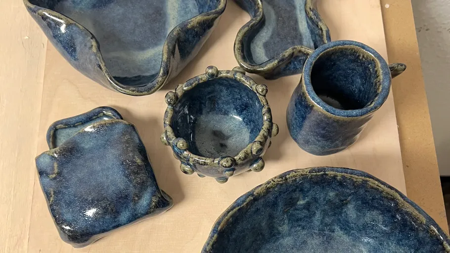 Blue ceramic dishes displayed on a wooden surface.