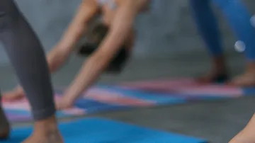 People practicing yoga on colorful mats.