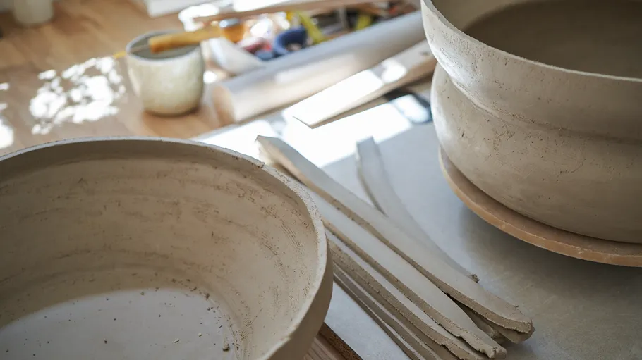 Clay bowls and strips on a table.