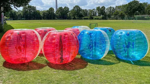 Plastic bubbles on grass in a park.