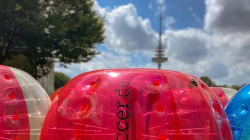 Plastic balls at park with tower visible.