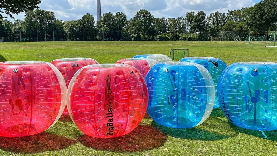 Inflatable bubble balls on a sports field.