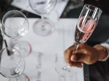 A champagne glass is held during a wine tasting session.