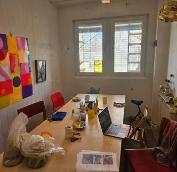 Art supplies on table in bright room.