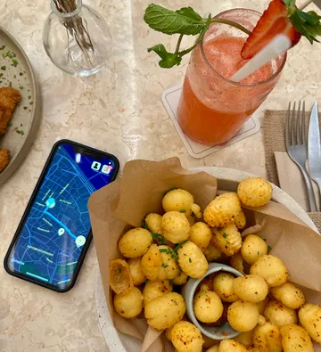 Snack, drink, and phone on a table.