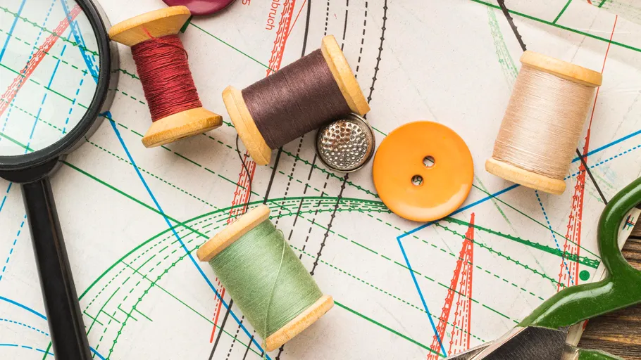 Spools of thread on sewing pattern.