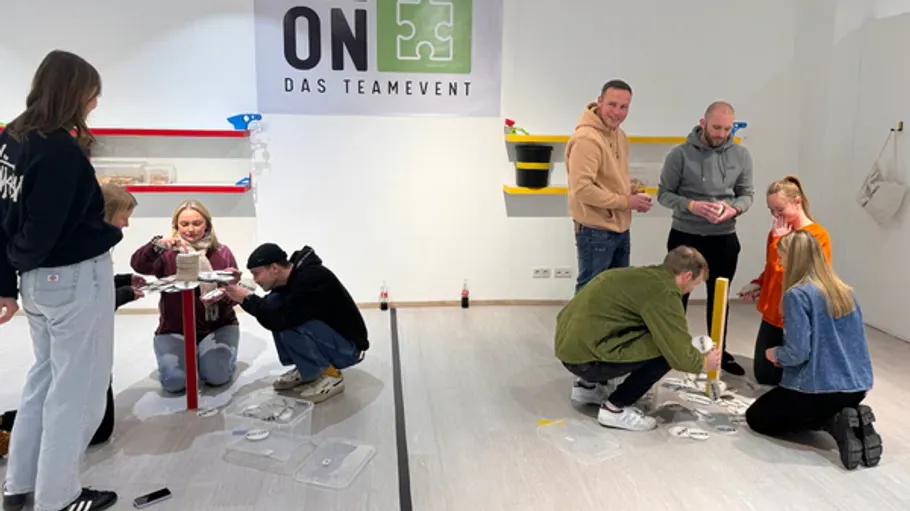 People collaborating in a team-building activity indoors.