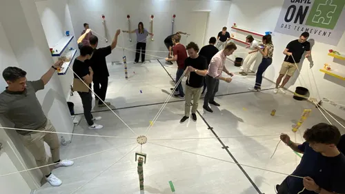 People playing team-building game indoors.