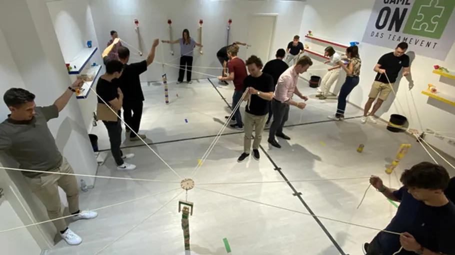 People playing team-building game indoors.
