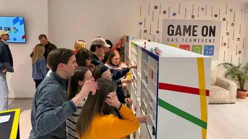 People engaging in team event puzzle activity.