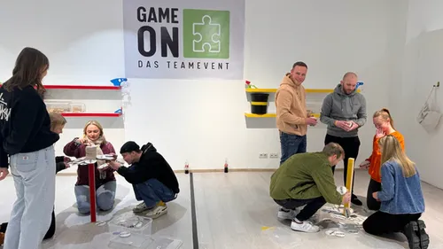 People building structures in a team event.