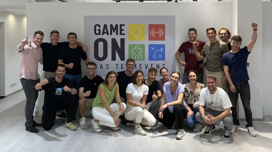 Group of people posing inside event space.