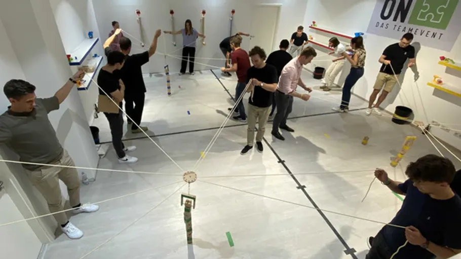 People participate in a team-building exercise indoors.